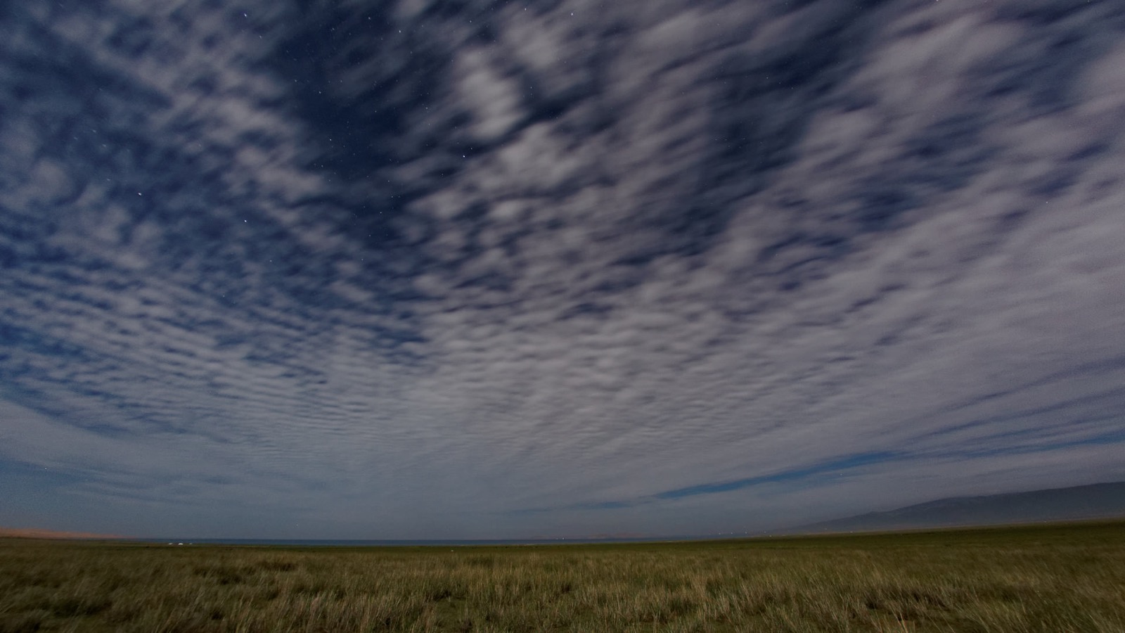 Qinghai Lake under a wide plateau sky.