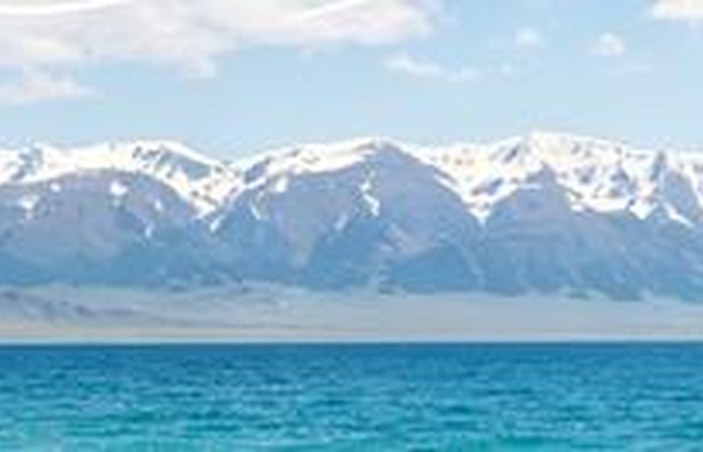 Sayram Lake deserves a weather window because blue water and snow peaks depend on light.