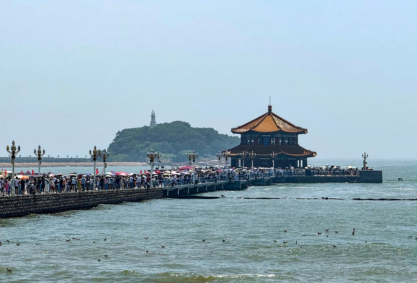 Zhanqiao Pier and Huilan Pavilion extending into Qingdao Bay.